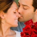 "A romantic couple sharing a heartfelt moment with a bouquet of premium red roses, perfect for Valentine’s Day and available for same-day flower delivery downtown Chicago."