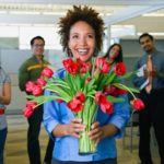 lady happy to receive roses at work for Valentine's Day